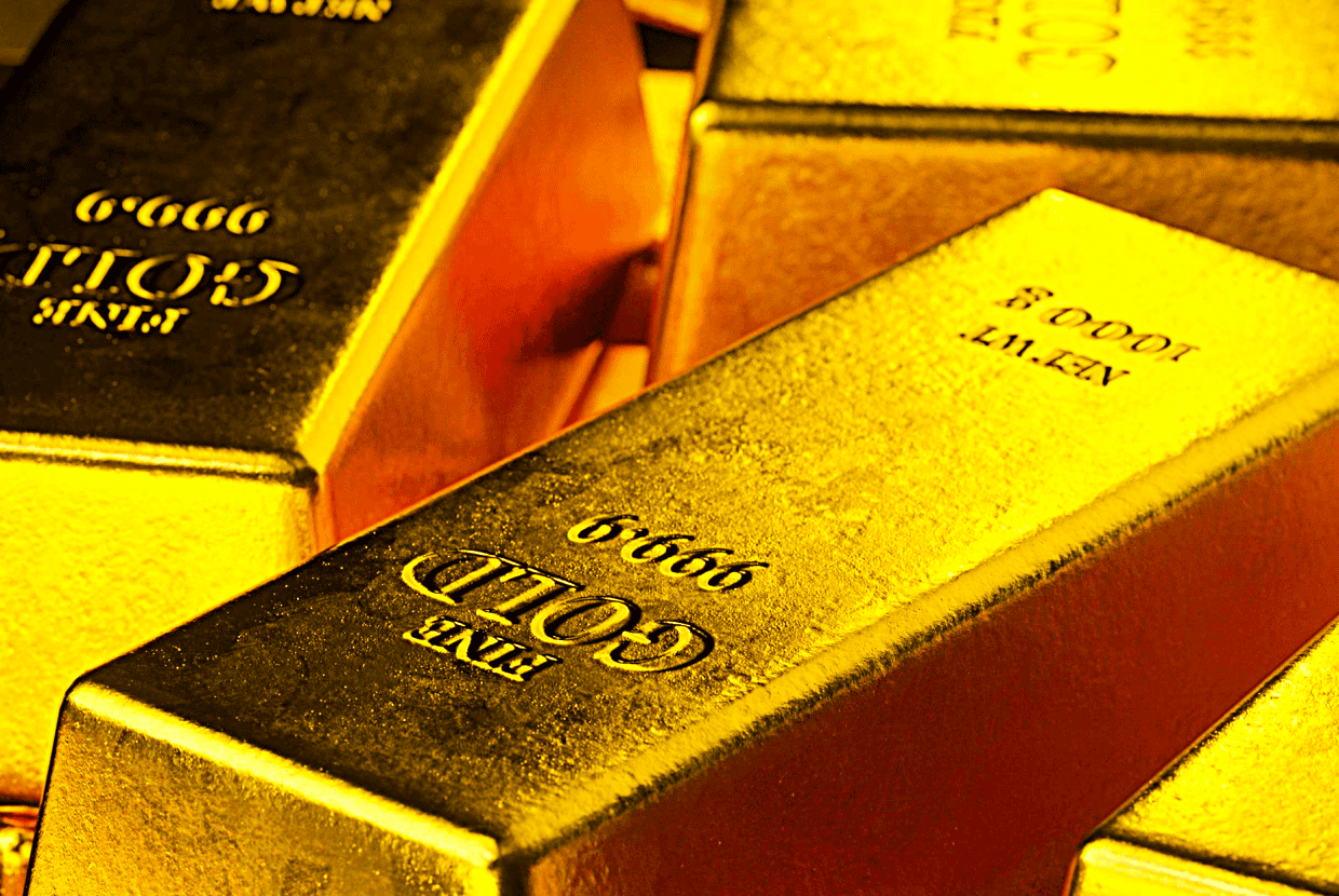 Close-up of stacked gold bullion bars with markings showing weight and purity.